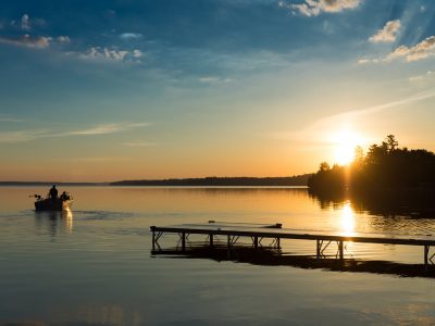 Cottage Life - Father and son fishing on a boat at sunrise/sunset at the peaceful cottage in Kawartha Lakes Ontario Canada on Balsam Lake